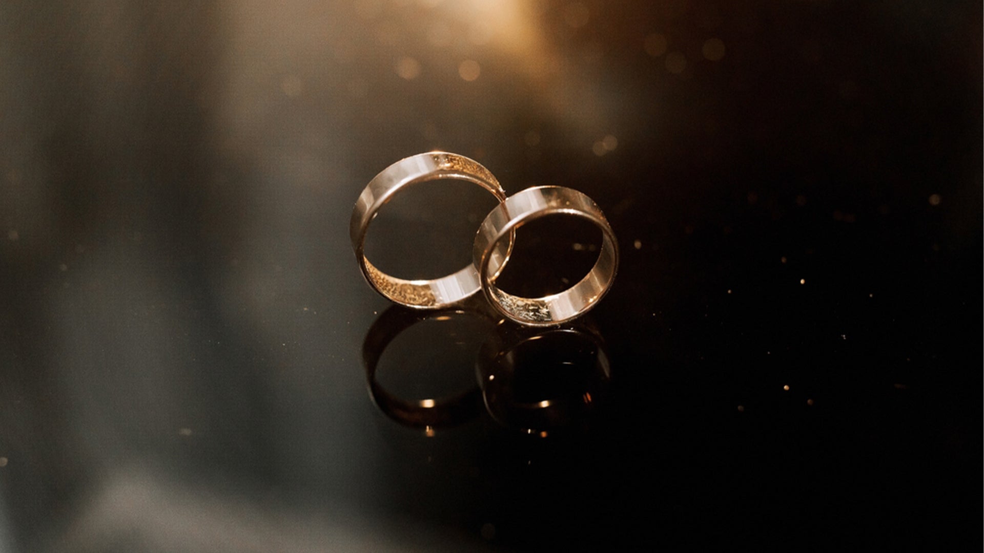 The image shows a pair of wedding rings, which are a symbol of love and commitment