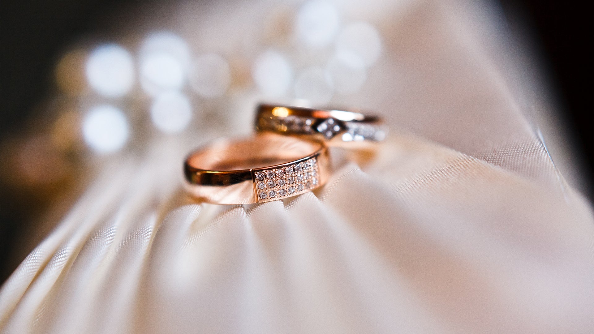 Two customized wedding rings elegantly displayed on a pristine white cloth highlighting their unique design and the bond of marriage